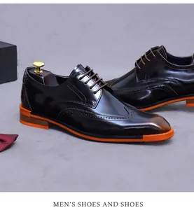 Detail of dark burgundy brogue dress shoes with vibrant orange sole and punch hole patterns
