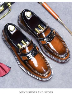 Close-up of premium brown gradient leather loafers with a silver buckle and wood shoe tree