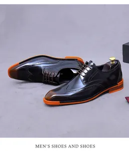 Detailed view of dark brown leather wingtip brogues with vibrant orange rubber soles
