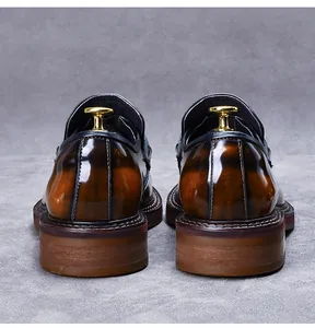 Detail view of the polished gradient brown leather heel on a chunky sole loafers