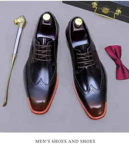 Flat lay of men's brogue leather shoes with glossy gradient finish and gentleman accessories