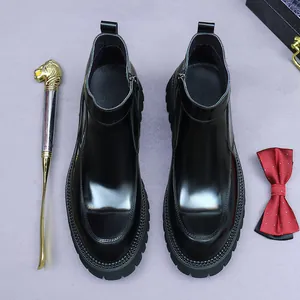 Glossy black leather Chelsea boots for men with thick rubber sole and side zippers