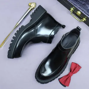 Polished black leather Chelsea boots with thick lug soles and side zipper details