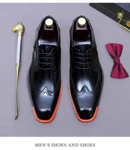 Top view of classic black leather brogue shoes with vibrant red contrast soles
