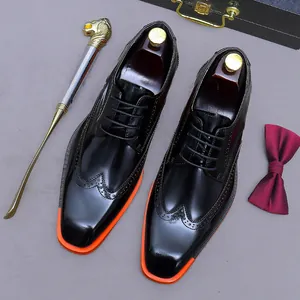 Polished black leather brogue shoes for men with contrasting orange sole and luxury accessories