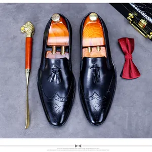 Detail of black tassel loafers with wingtip brogue patterns and premium shoe trees