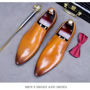 Detail of men's brown leather dress shoes with burnished toe and premium wooden shoe tree
