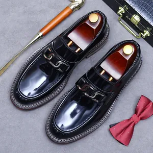 Polished black leather loafers for men featuring a round toe and vintage metal chain link