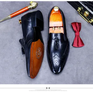 Detail of black leather brogue shoes with tassels and handmade sole craftsmanship
