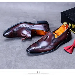 Detailed close-up of burgundy brogue leather shoes with tassel decor and perforation