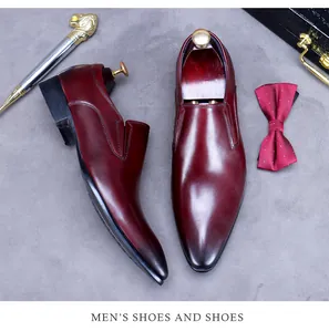 Polished burgundy leather men's dress shoes with metal lion head cane on marble surface