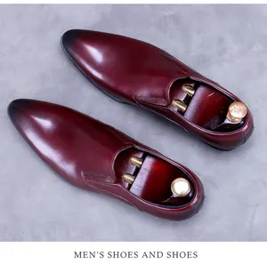 Top-down view of polished burgundy leather business shoes with elegant black gradient toe