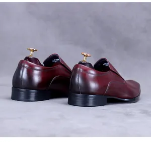 Detail of hand-burnished wine red leather heel and inner sizing on mens formal loafers