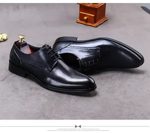Detailaufnahme schwarzer Leder-Derby-Schuh mit Brogue-Verzierung und hölzernem Schuhspanner