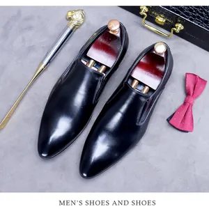 Detail of glossy black leather loafers with luxury shoe trees and gentleman accessories