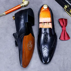 Classic black leather loafers with wingtip brogue detailing and elegant tassels