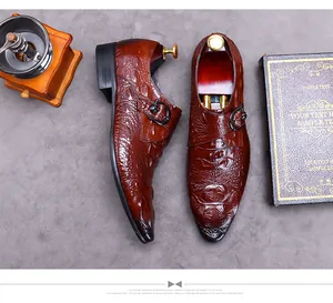 Top view of brown crocodile embossed leather monk shoe with metallic buckle and shoe tree