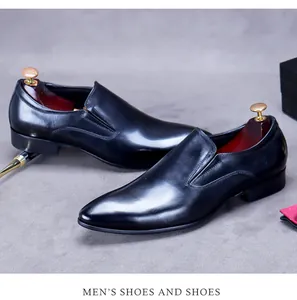 Close-up of black genuine leather dress shoes with wooden shoe tree and luxury props