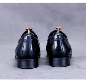 Detail of heel stitching and wood-textured heel on men's leather business shoes