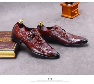 Detailed view of crocodile texture on dark brown leather monk strap shoes with metal buckle
