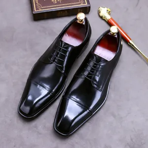 Classic men's black leather cap-toe dress shoes with wooden trees and shoe horn
