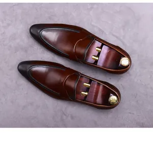 Detailed top view of dark brown polished leather penny loafers with elegant wood shoe trees