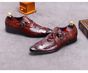 Macro view of dark brown crocodile pattern monk strap leather shoe with burnished toe