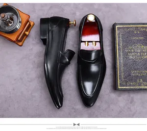 Top view of black patent leather men's business loafers with classic pointed toe design
