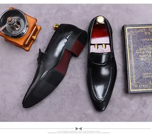 Polished black leather men's dress shoes with vintage book and coffee grinder props
