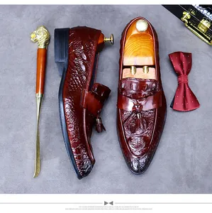Detailed view of leather loafer with crocodile embossing and elegant tassel accents