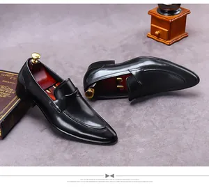 Top view of classic black leather loafers with luxury wooden shoe trees and retro decor