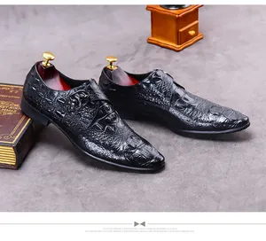 Detailed macro view of black crocodile embossed leather on a single monk strap shoe