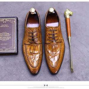 Detailed top view of brown embossed leather dress shoes with luxury shoe trees and shoehorn