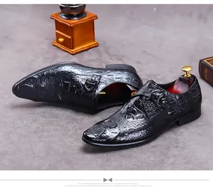 Detail of black crocodile embossed leather monk strap shoe with polished metal buckles