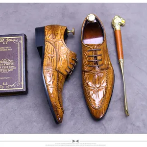 Macro shot of men's brown oxford leather shoes with crocodile embossed pattern