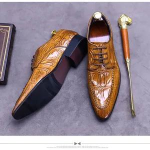 Macro detail of brown crocodile embossed leather and stitching on men's derby dress shoes