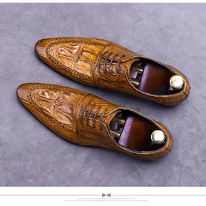 Top view of men's leather derby shoes with crocodile embossed texture and shoe trees