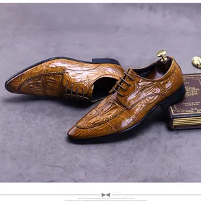 Close-up of brown crocodile-embossed leather business shoes with intricate woven stitching