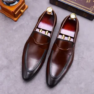 Deep brown leather loafers for men with pointed toe design on textured grey surface
