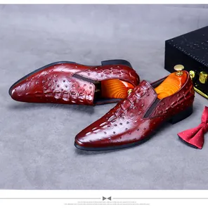 Detail of luxury bordeaux red crocodile and ostrich pattern leather men shoes with bow tie
