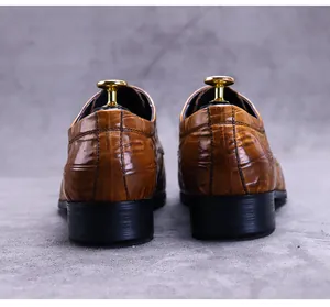 Rear view of men's leather business shoes featuring brown crocodile skin embossing