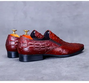 Detailed view of men's leather dress shoe with ostrich and crocodile texture embossing