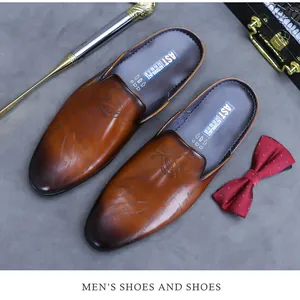 Detailed shot of brown gradient leather mules with vintage engraving and business accessories