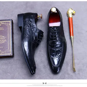 Detail of black embossed leather oxfords with wooden shoe tree and golden lion shoehorn