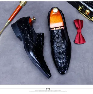 Macro shot of black embossed crocodile pattern leather shoes with luxury accessories