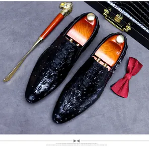 Close-up of black crocodile pattern leather loafers with luxury cedar wood shoe trees