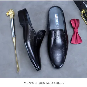 Detailed top view of brown leather business mules featuring vintage engraved patterns