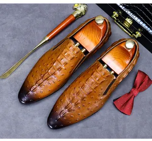 Detail of tan crocodile embossed leather dress shoe with gradient burnished toe