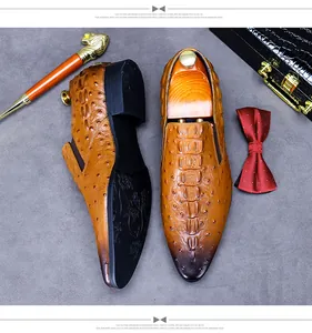 Detail of brown leather oxford shoes with crocodile pattern and vintage accessories