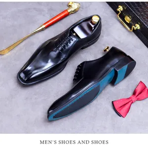 Top view of premium black leather oxford shoes with blue accents on the sole and lifestyle props